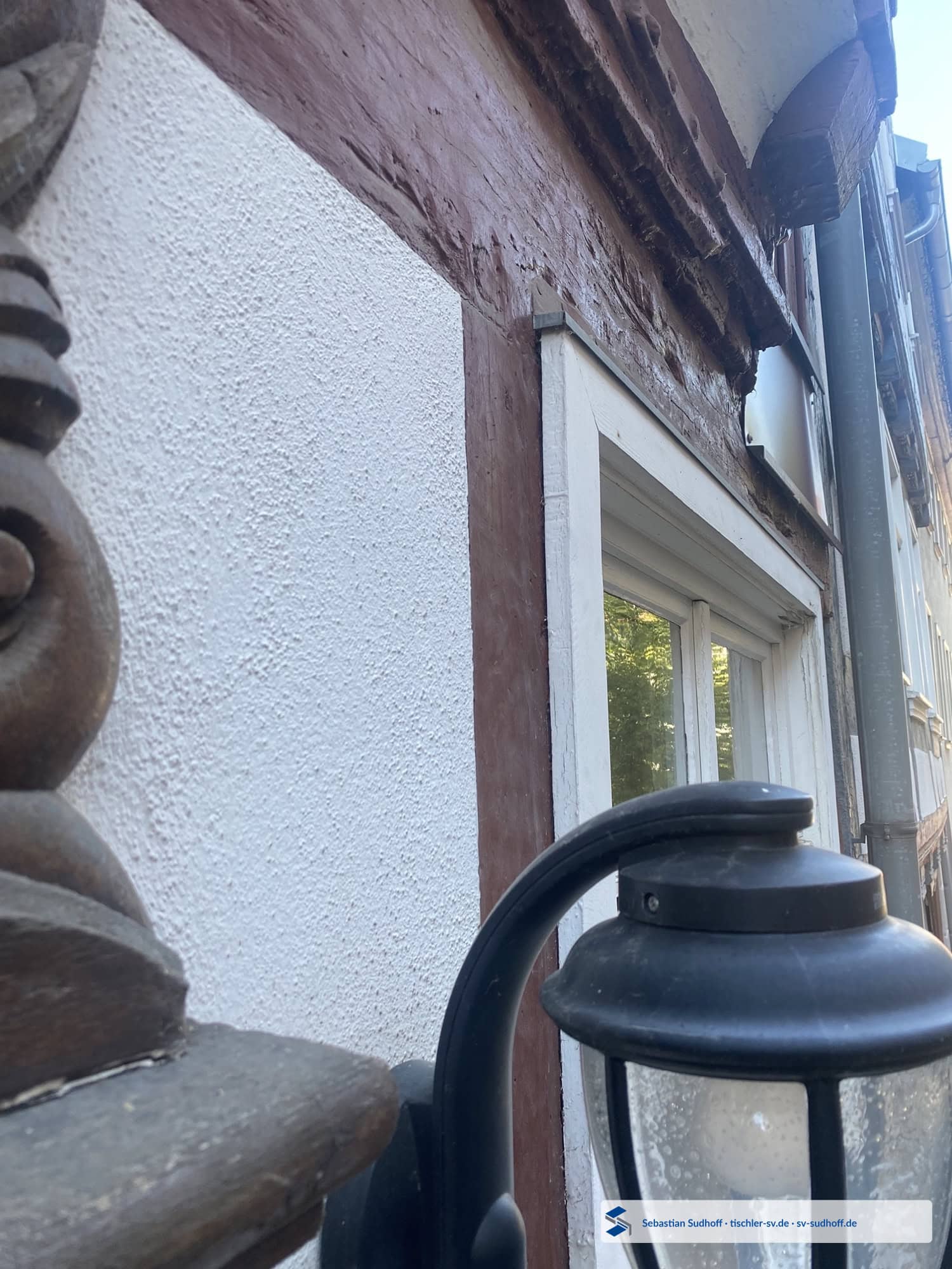 Detail des oberen Fensteranschlusses mit schützendem Dachüberstand