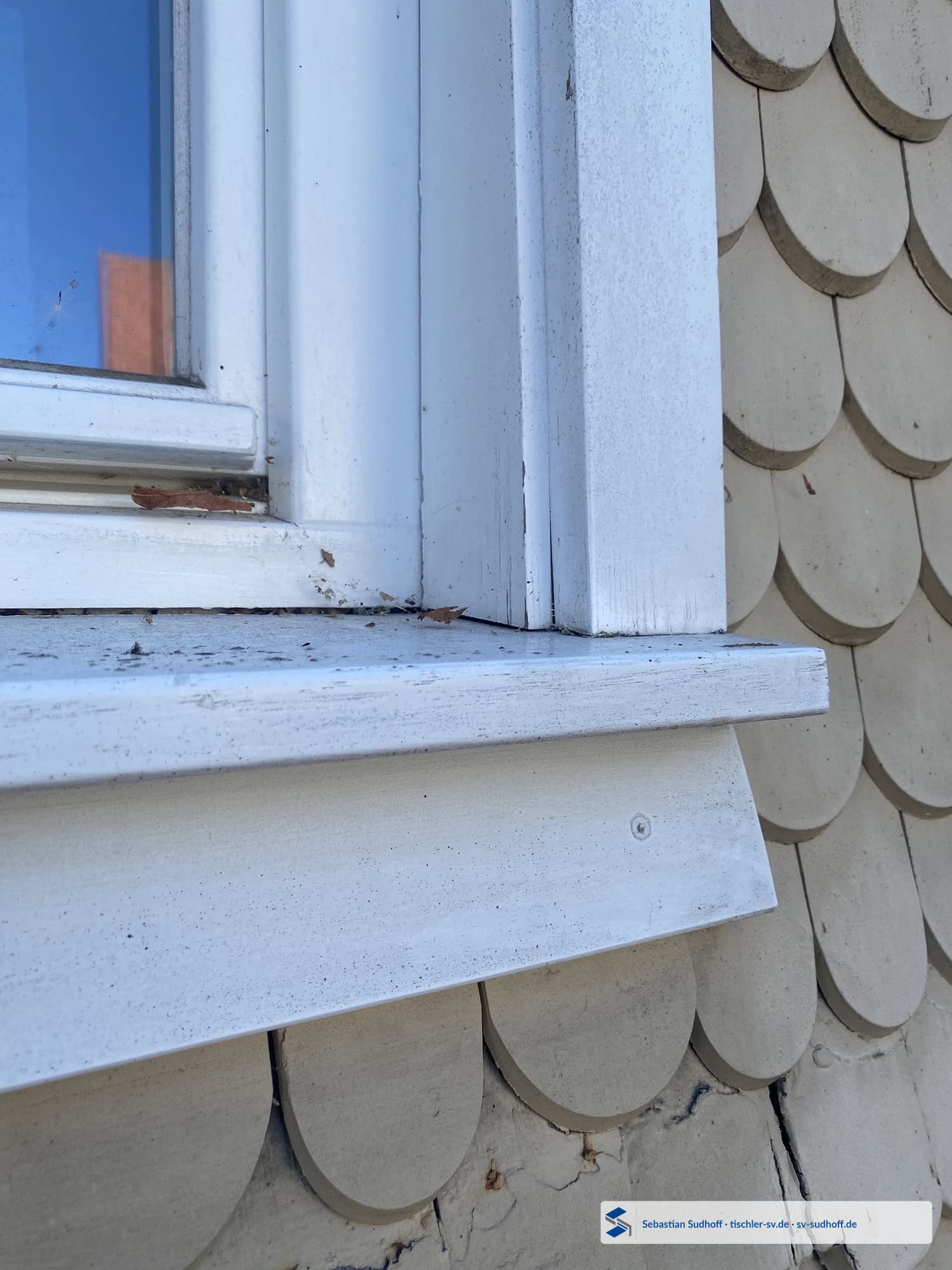 Geschädigter Fensterbankanschluss an einem modernen Holzfenster